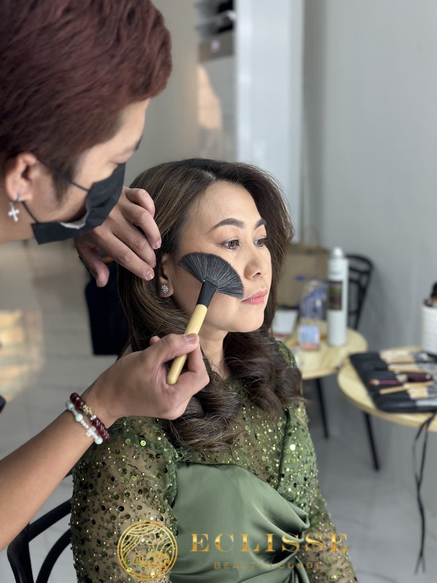 Makeup artist applying soft glam makeup at Eclisse Beauty Lounge